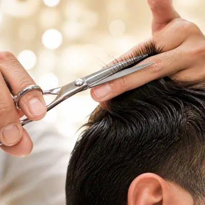 Campaign photograph illustrating Men's haircut with scissors