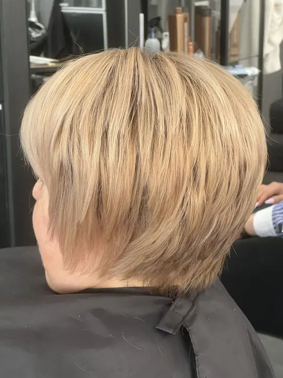 Short layered blonde cut with textured ends