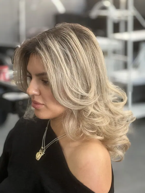 Blonde blow-dry with bouncy face-framing curls