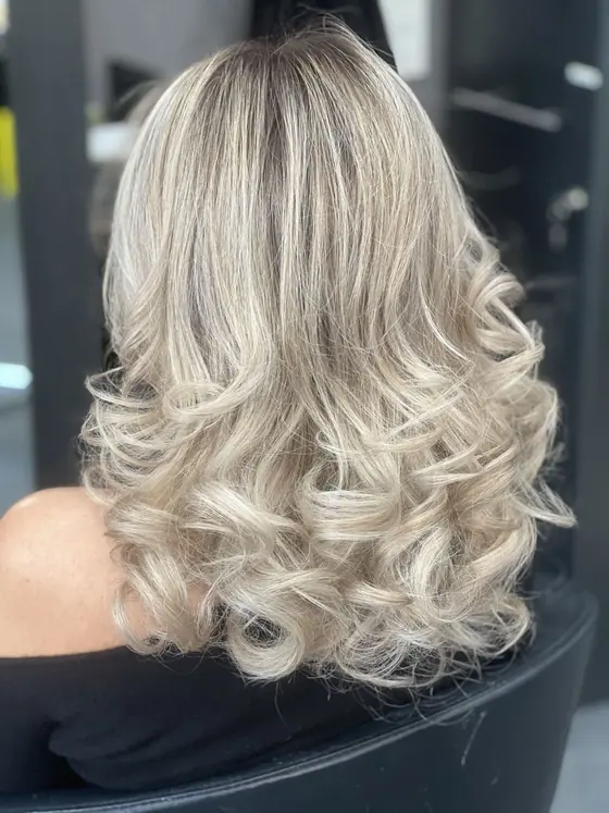 Silver blonde hair set in wide barrel curls