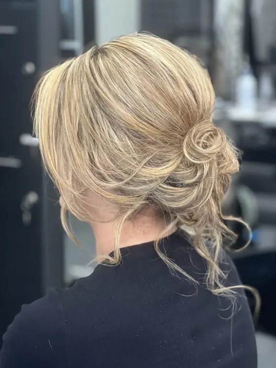 Undone blonde updo with loose face-framing pieces