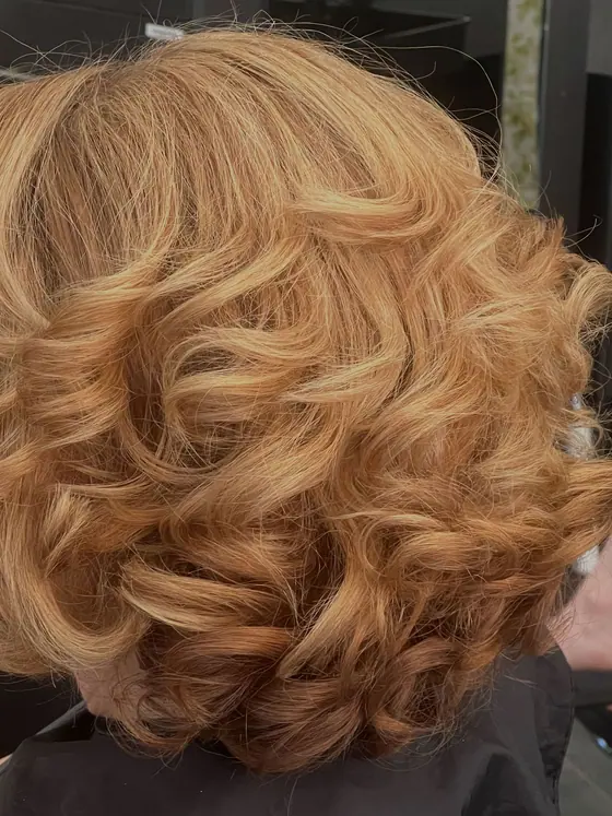 Strawberry blonde color set in curls