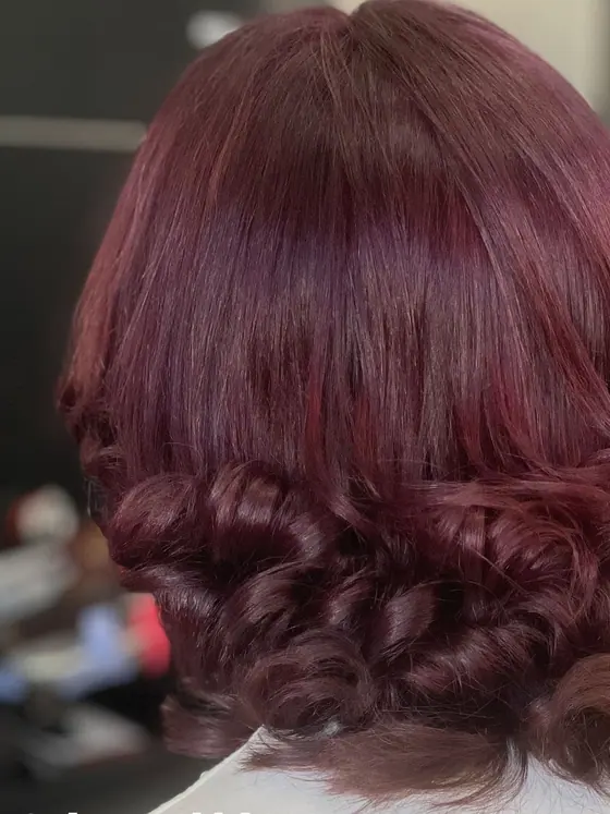 Burgundy curls on a shoulder-length cut