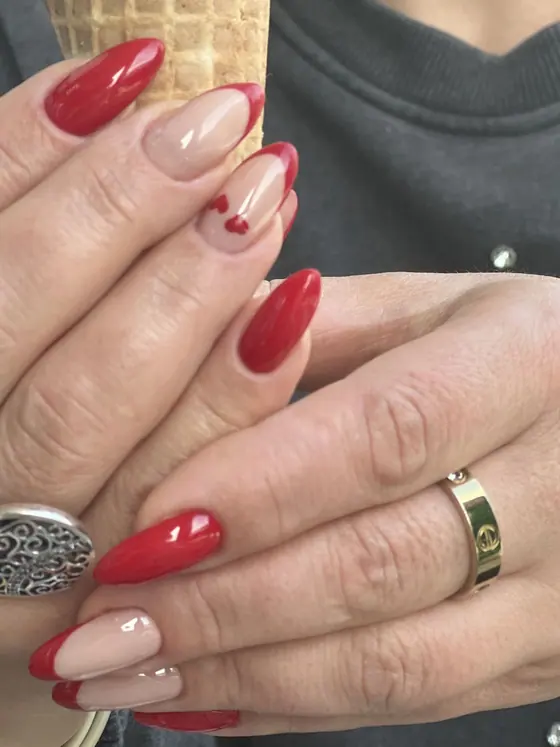 Red gel manicure with a nude accent nail